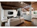 Comfortable living room with vaulted wood ceiling, fireplace, hardwood floors, and lots of natural light at 3473 Regalwoods Dr, Atlanta, GA 30340
