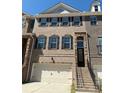 Attractive brick townhome with a private garage, a welcoming entrance, and classic black shutters at 4121 Townsend Ln, Atlanta, GA 30346