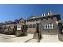 A row of elegant townhomes, each with a private garage and inviting entry staircase at 4121 Townsend Ln, Atlanta, GA 30346