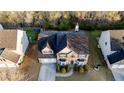 Aerial view of a well-maintained house with a two-car garage, a manicured lawn, and mature trees at 4033 Roxberry Hill Ln, Buford, GA 30518