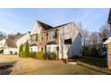 Side view of a lovely two-story home with stone accents, manicured bushes, and a basketball hoop at 4033 Roxberry Hill Ln, Buford, GA 30518