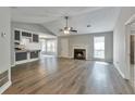 Open concept living room featuring hardwood floors, fireplace, and vaulted ceiling at 2220 Golden Valley Dr, Lawrenceville, GA 30043