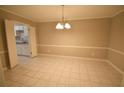 Large dining room is brightly lit with a modern chandelier, and is adjacent to the kitchen at 37 Le Parc Fontaine, Lithonia, GA 30038