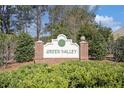 Green Valley community sign surrounded by lush landscaping and greenery at 3045 Hendrick Dr, Mcdonough, GA 30253