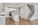 Modern kitchen featuring an island, stainless appliances, and elegant pendant lighting, ideal for culinary enthusiasts at 104 Briargate Dr, Johns Creek, GA 30097