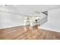 Open-concept living space with gleaming hardwood floors, flowing seamlessly into a modern, well-equipped kitchen at 104 Briargate Dr, Johns Creek, GA 30097