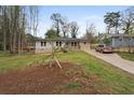Lovely home featuring stone accents, a driveway, and a newly planted tree in the front yard at 1752 Atherton Dr, Decatur, GA 30035