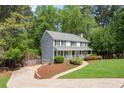 Lovely home with a long driveway, well-maintained lawn and attractive landscaping at 2731 Old Coach Rd, Duluth, GA 30096