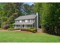 Beautiful home featuring a classic design, lush green lawn and mature trees at 2731 Old Coach Rd, Duluth, GA 30096