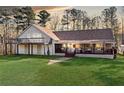 Beautiful home featuring a lush green lawn, spacious front porch, and inviting curb appeal at 998 Sisley Trl, White, GA 30184