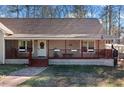 Close up of charming front porch with cozy seating and a welcoming entrance at 998 Sisley Trl, White, GA 30184