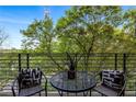 Cozy balcony with a bistro set, offering a serene outdoor space surrounded by lush greenery at 112 Rogers Ne St # 503, Atlanta, GA 30317