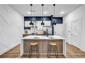 Modern kitchen featuring a large island, stainless steel appliances, pendant lighting, and stylish counter stools at 112 Rogers Ne St # 503, Atlanta, GA 30317