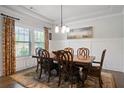 Elegant dining room featuring a wooden table with seating for six and a decorative chandelier at 1151 Wisteria Sw Dr, Mableton, GA 30126