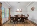 Elegant dining room featuring a wooden table with seating for six and a decorative chandelier at 1151 Wisteria Sw Dr, Mableton, GA 30126