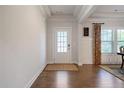 Inviting entryway with a stylish front door, hardwood floors, and decorative trim at 1151 Wisteria Sw Dr, Mableton, GA 30126