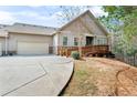 Inviting home exterior showcasing a two-car garage, charming entrance, and a cozy front yard at 2417 Tree Arbor Way, Marietta, GA 30064