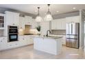 Bright, modern kitchen featuring white cabinets, stainless steel appliances, and granite countertops at 5210 Davenport Pl, Roswell, GA 30075