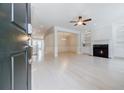 Bright open-concept living room with fireplace, built-in shelves, and fresh white paint at 5210 Davenport Pl, Roswell, GA 30075
