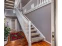 Bright foyer with hardwood floors, staircase, and view into adjacent hallway at 58 Basswood Cir # 29, Atlanta, GA 30328