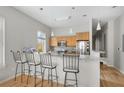 Modern kitchen with granite countertops, a breakfast bar with seating, stainless steel appliances, wooden cabinets, and hardwood floors at 1430 Dresden Ne Dr # 215, Atlanta, GA 30319