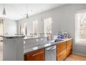 Modern kitchen with granite countertops, wood cabinets, stainless steel appliances and fixtures, and a breakfast bar with pendant lighting at 1430 Dresden Ne Dr # 215, Atlanta, GA 30319