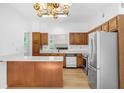 Functional kitchen featuring stainless steel appliances, wood cabinets, and a breakfast bar for casual dining at 165 River Ridge Ln, Roswell, GA 30075