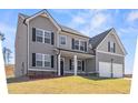 Attractive two-story house boasts neutral siding, balanced windows with shutters, and a charming front porch at 469 Ralph Still Rd, Dacula, GA 30019