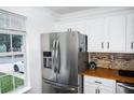 Modern kitchen with stainless steel appliances and adjacent bright window at 811 Heritage Valley Rd, Norcross, GA 30093