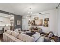 Spacious living room featuring hardwood floors, modern decor, and an open layout to the kitchen at 2520 Peachtree Rd # 602, Atlanta, GA 30305