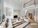 Bright living room with fireplace, built-in bookshelves, soaring ceilings, and a view to the second level at 3083 Milledge Gate Se Ct, Marietta, GA 30067
