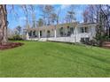 Lovely one-story home with a large front yard, brick exterior, and inviting front porch at 1342 Bertha Way, Marietta, GA 30062