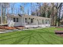 Well-maintained home featuring a brick facade, complemented by a lush green lawn at 1342 Bertha Way, Marietta, GA 30062