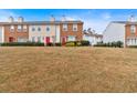 View of townhomes with well-manicured lawns in a residential community at 219 Holcomb Ferry Rd, Roswell, GA 30076