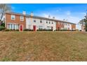 A row of townhomes with varied facades and a sloping front lawn at 219 Holcomb Ferry Rd, Roswell, GA 30076