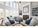 Bright living room with large windows, high ceilings, fireplace, and comfortable seating at 5303 Whitehaven Park Se Ln, Smyrna, GA 30126