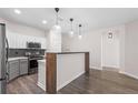Bright kitchen featuring stylish pendant lighting, gray cabinets and wood flooring at 1955 Nocturne Dr # 3301, Alpharetta, GA 30009