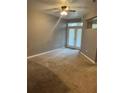 Bedroom featuring neutral walls, carpeted floor, and doors leading to balcony at 390 17Th St # 2059, Atlanta, GA 30363