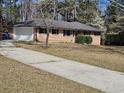 Lovely brick home featuring a convenient garage and beautiful landscape at 3685 Emily Way, Atlanta, GA 30349
