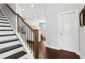 Staircase view showing wood floors and modern metal railing detail with an open view to living spaces at 5726 Taylor Way, Sandy Springs, GA 30342