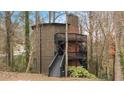 Three-story home with multi-level decks and black railings at 595 Overbrook Nw Dr, Atlanta, GA 30318