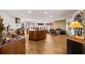 Spacious kitchen and living area with a unique island, wood floors, fireplace, and abundant natural light from large windows at 595 Overbrook Nw Dr, Atlanta, GA 30318