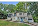 Inviting exterior view of home featuring well-maintained lawn, brick accents, and an attached one car garage at 656 Channing Nw Dr, Atlanta, GA 30318