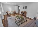 Cozy living room with hardwood floors, neutral walls, area rug, and comfortable seating arrangement at 656 Channing Nw Dr, Atlanta, GA 30318
