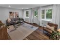 Bright living room features hardwood floors, neutral walls, ample natural light, and modern furnishings at 656 Channing Nw Dr, Atlanta, GA 30318