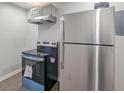 Close-up showcasing stainless steel refrigerator and modern electric range, highlighting kitchen appliances at 1672 Thornton Pl, Atlanta, GA 30315