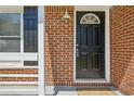 A welcoming front door is framed by classic brickwork and white trim, creating a warm entrance at 2792 Toney Dr, Decatur, GA 30032