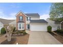 Charming two-story home featuring a two-car garage, bay window and classic brick accents at 331 Greystone Pkwy, Hiram, GA 30141