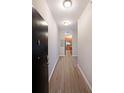 Inviting hallway featuring wood floors and a glimpse into the modern kitchen at 5300 Peachtree Rd. # 3107, Chamblee, GA 30341