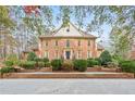 Handsome two-story home with brick exterior, manicured landscaping, and a grand entrance, exuding curb appeal at 540 Saint James Pl, Marietta, GA 30064